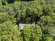 A bird's eye view captures a house surrounded by a sea of green trees at 2001 Lovdal Dr, Raleigh, NC 27613