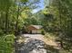 Aerial view of home with driveway and attached garage surrounded by woods at 2001 Lovdal Dr, Raleigh, NC 27613