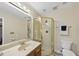 Modern bathroom featuring a glass-enclosed shower, vanity sink, and neutral color scheme at 2001 Lovdal Dr, Raleigh, NC 27613