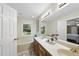 Bright bathroom with double sinks, a large mirror, and a separate bathtub at 2001 Lovdal Dr, Raleigh, NC 27613