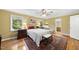 Inviting bedroom featuring hardwood floors, two bedside tables, and abundant natural light at 2001 Lovdal Dr, Raleigh, NC 27613