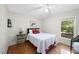 Cozy bedroom with hardwood floors, a comfortable bed, and a window view to the green outdoors at 2001 Lovdal Dr, Raleigh, NC 27613