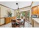 Cozy dining room with bay window, chandelier, wooden table and built in cabinets at 2001 Lovdal Dr, Raleigh, NC 27613
