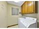 Functional laundry area equipped with a washer, dryer, and storage cabinets for organized convenience at 2001 Lovdal Dr, Raleigh, NC 27613