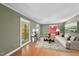 A cozy living room with hardwood floors, large windows, and a stylish seating arrangement at 2001 Lovdal Dr, Raleigh, NC 27613