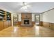Spacious living room with a brick fireplace, hardwood floors and access to the outdoor space at 2001 Lovdal Dr, Raleigh, NC 27613