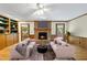 Spacious living room with a fireplace, ceiling fan, and access to the outdoor patio at 2001 Lovdal Dr, Raleigh, NC 27613