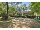 A brick ranch home features a screened-in porch and mature landscaping at 2001 Lovdal Dr, Raleigh, NC 27613