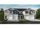 Charming townhome exterior with attached garages, neutral siding, and well-maintained landscaping at 2003 Oakdale Dr, Durham, NC 27704