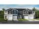 Modern townhome exterior showcasing a private garage and neutral color palette at 2027 Oakdale Dr, Durham, NC 27703
