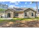 Backyard view of the home with a sliding glass door that leads to a concrete patio at 217 Griffis Dr, Stem, NC 27581