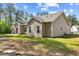 The home features a cozy back yard with grassy areas and mature trees at 217 Griffis Dr, Stem, NC 27581