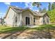 The home features a cozy back yard with grassy areas and mature trees at 217 Griffis Dr, Stem, NC 27581