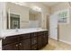 Bathroom with double sink vanity, a large mirror, and lots of lighting at 217 Griffis Dr, Stem, NC 27581