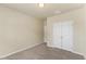 An empty bedroom with neutral paint and carpet and featuring a closet and door at 217 Griffis Dr, Stem, NC 27581