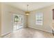 Bright dining area with sliding glass doors, light colored walls and tile flooring at 217 Griffis Dr, Stem, NC 27581