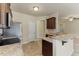 Bright kitchen features granite countertops, dark wood cabinetry and stainless appliances at 217 Griffis Dr, Stem, NC 27581