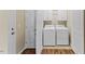 Well-lit laundry room featuring a modern washer and dryer and white cabinets at 217 Griffis Dr, Stem, NC 27581