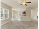 Spacious living area with carpet, fireplace, and views of the kitchen, creating an inviting open-concept layout at 217 Griffis Dr, Stem, NC 27581