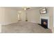 Expansive living room with plush carpet, fireplace, and sightlines to kitchen and dining areas, perfect for entertaining at 217 Griffis Dr, Stem, NC 27581