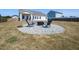 Backyard featuring a stone fire pit area and comfortable seating, perfect for outdoor entertaining and relaxation at 218 E Tecoma Ln, Clayton, NC 27520