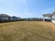 Spacious backyard features a well-maintained lawn, a fire pit area, and a covered patio at 218 E Tecoma Ln, Clayton, NC 27520