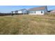 Large fenced backyard featuring a fire pit, and ample space for outdoor activities and entertaining at 218 E Tecoma Ln, Clayton, NC 27520