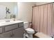 Bathroom featuring a shower with a modern curtain and neutral walls at 218 E Tecoma Ln, Clayton, NC 27520