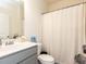Clean bathroom with a white shower curtain, toilet, and vanity at 218 E Tecoma Ln, Clayton, NC 27520