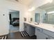 The bathroom features double sinks, a large mirror, and access to the primary bedroom at 218 E Tecoma Ln, Clayton, NC 27520
