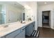 Bathroom features a double vanity, large mirror, and access to the walk-in closet at 218 E Tecoma Ln, Clayton, NC 27520