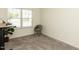 Bedroom with a window view and grey chair at 218 E Tecoma Ln, Clayton, NC 27520