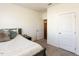 Bedroom featuring a comfortable queen bed and ensuite bathroom access at 218 E Tecoma Ln, Clayton, NC 27520