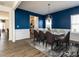 Modern dining room showcasing elegant lighting, a marble top table, stylish chairs, and bold blue accent wall at 218 E Tecoma Ln, Clayton, NC 27520