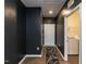 Hallway with dark walls and wood floors leading to the laundry room at 218 E Tecoma Ln, Clayton, NC 27520