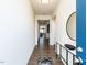 Bright hallway with wood floors, leading to living spaces, and a modern console table at 218 E Tecoma Ln, Clayton, NC 27520