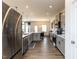 Open concept kitchen featuring stainless steel appliances, gray cabinets, pendant lighting, and expansive countertops at 218 E Tecoma Ln, Clayton, NC 27520