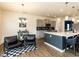Open concept kitchen featuring stainless steel appliances, gray cabinets, pendant lighting, and eat in bar seating at 218 E Tecoma Ln, Clayton, NC 27520