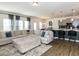 Open concept living room featuring comfortable seating, a modern media center, neutral walls, and access to the kitchen at 218 E Tecoma Ln, Clayton, NC 27520