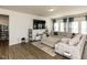Spacious living room featuring comfortable seating, a modern media center, neutral walls, and bright lighting at 218 E Tecoma Ln, Clayton, NC 27520