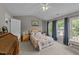 Bright bedroom with vaulted ceiling, ceiling fan, and multiple windows offering natural light at 228 Honeywell Way, Fuquay Varina, NC 27526