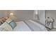 Relaxing bedroom with neutral tones and bedding, featuring a glimpse into the bathroom at 228 Honeywell Way, Fuquay Varina, NC 27526