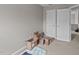 Bright bedroom with two doors, neutral carpeting and decor, and packing boxes at 228 Honeywell Way, Fuquay Varina, NC 27526