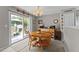 A cozy dining area features a wooden table, chairs, and sliding glass doors leading to the backyard at 228 Honeywell Way, Fuquay Varina, NC 27526