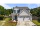 Charming two-story home featuring a two-car garage, well-manicured lawn, and inviting curb appeal at 228 Honeywell Way, Fuquay Varina, NC 27526
