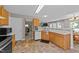 Functional kitchen with wood cabinets, white countertops, and an open layout at 228 Honeywell Way, Fuquay Varina, NC 27526