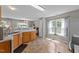 Bright kitchen featuring wood cabinets, laminate floor, and plenty of natural light at 228 Honeywell Way, Fuquay Varina, NC 27526