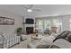 Comfortable living room with fireplace, ceiling fan, and a relaxing atmosphere at 228 Honeywell Way, Fuquay Varina, NC 27526