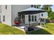 Back patio features a patio set, modern hanging chair, and lush lawn at 228 Honeywell Way, Fuquay Varina, NC 27526