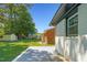 View of the side of the property and a large, fenced backyard with lush lawn at 2311 Wintergreen Pl, Durham, NC 27707